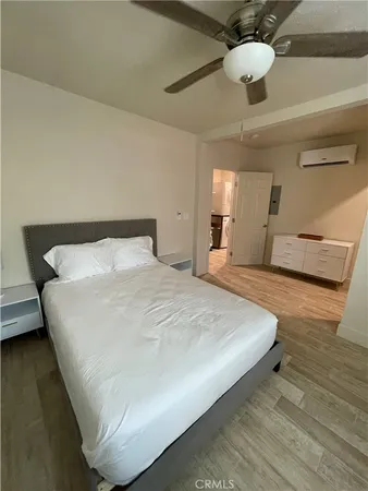 a large bed sitting in a bedroom and chandelier