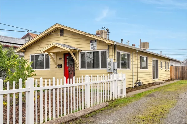 a front view of a house with wooden fence