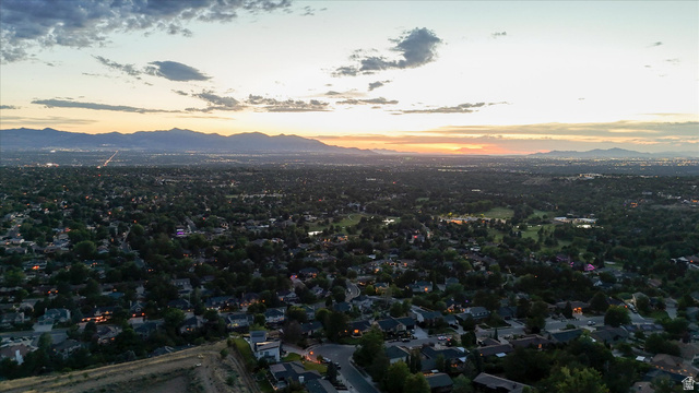 8760 Rustler Road Cottonwood Heights, UT 84093 - Photo 53 of 57 Expansive aerial panorama showcasing a suburban landscape with a distant mountain range