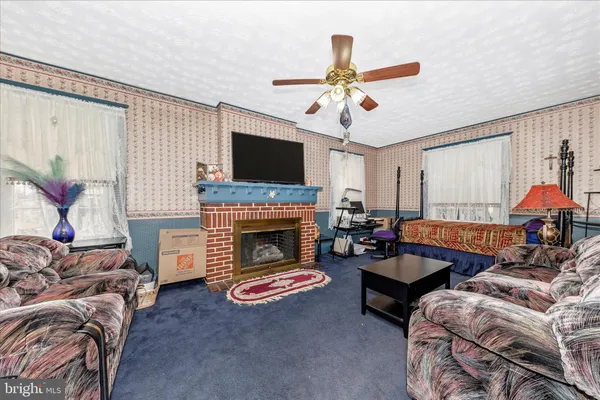 a living room with furniture a fireplace and a flat screen tv