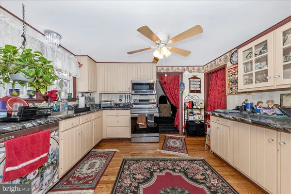 a kitchen with stainless steel appliances granite countertop a sink dishwasher stove and cabinets