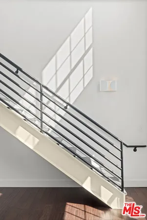 a bedroom with a bed and a window with wooden floor