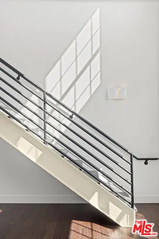 a bedroom with a bed and a window with wooden floor
