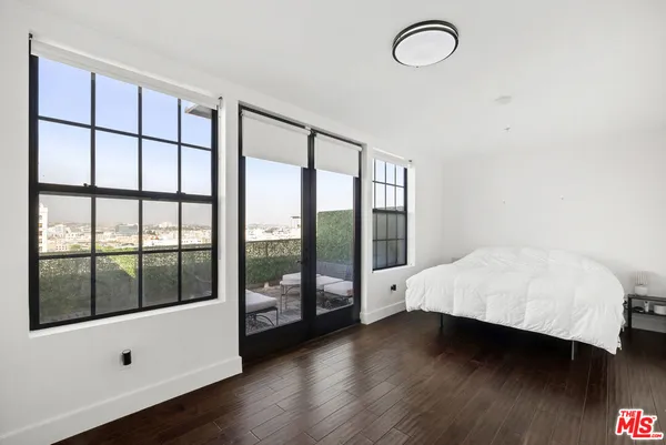 a bathroom with a granite countertop sink toilet and mirror