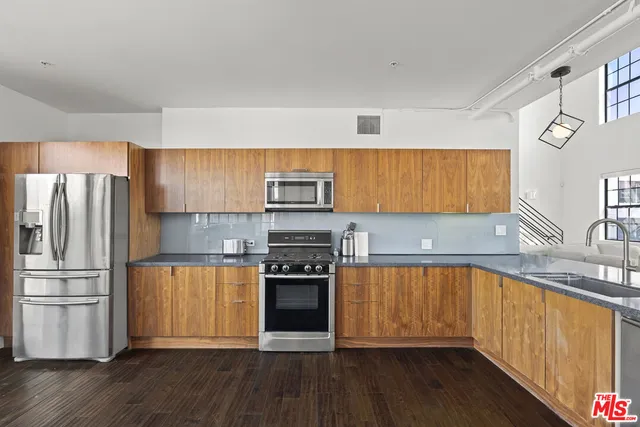 a kitchen with stainless steel appliances a stove top oven