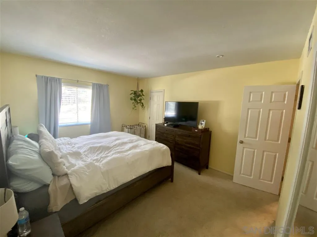 2616 Alpine Boulevard, Unit 29 Alpine, CA 91901 - Photo 15 of 20 a bedroom with a bed and a flat screen tv