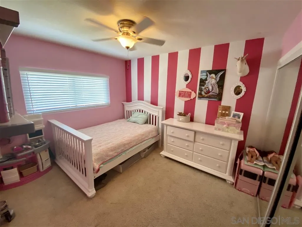 2616 Alpine Boulevard, Unit 29 Alpine, CA 91901 - Photo 18 of 20 a bedroom with a bed and a chandelier