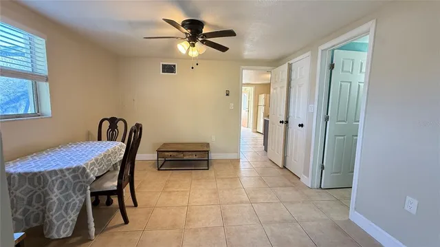 a view of a hallway with workspace and a window
