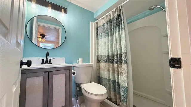 a bathroom with a toilet a sink and a mirror