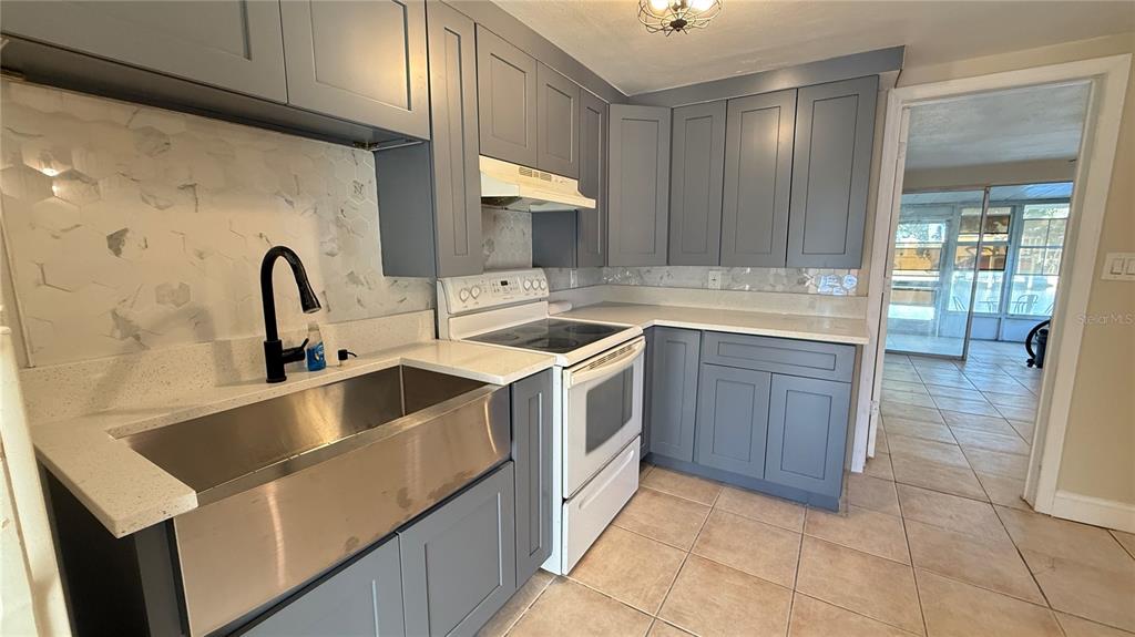 12611 1st Isle Hudson, FL 34667 - Photo 7 of 19 a kitchen with a sink and a stove top oven