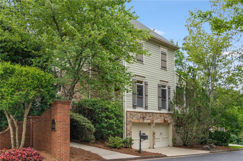 2430 Medlock Cmns Decatur, GA 30030 - Photo 1 of 1 a front view of a house with a garden