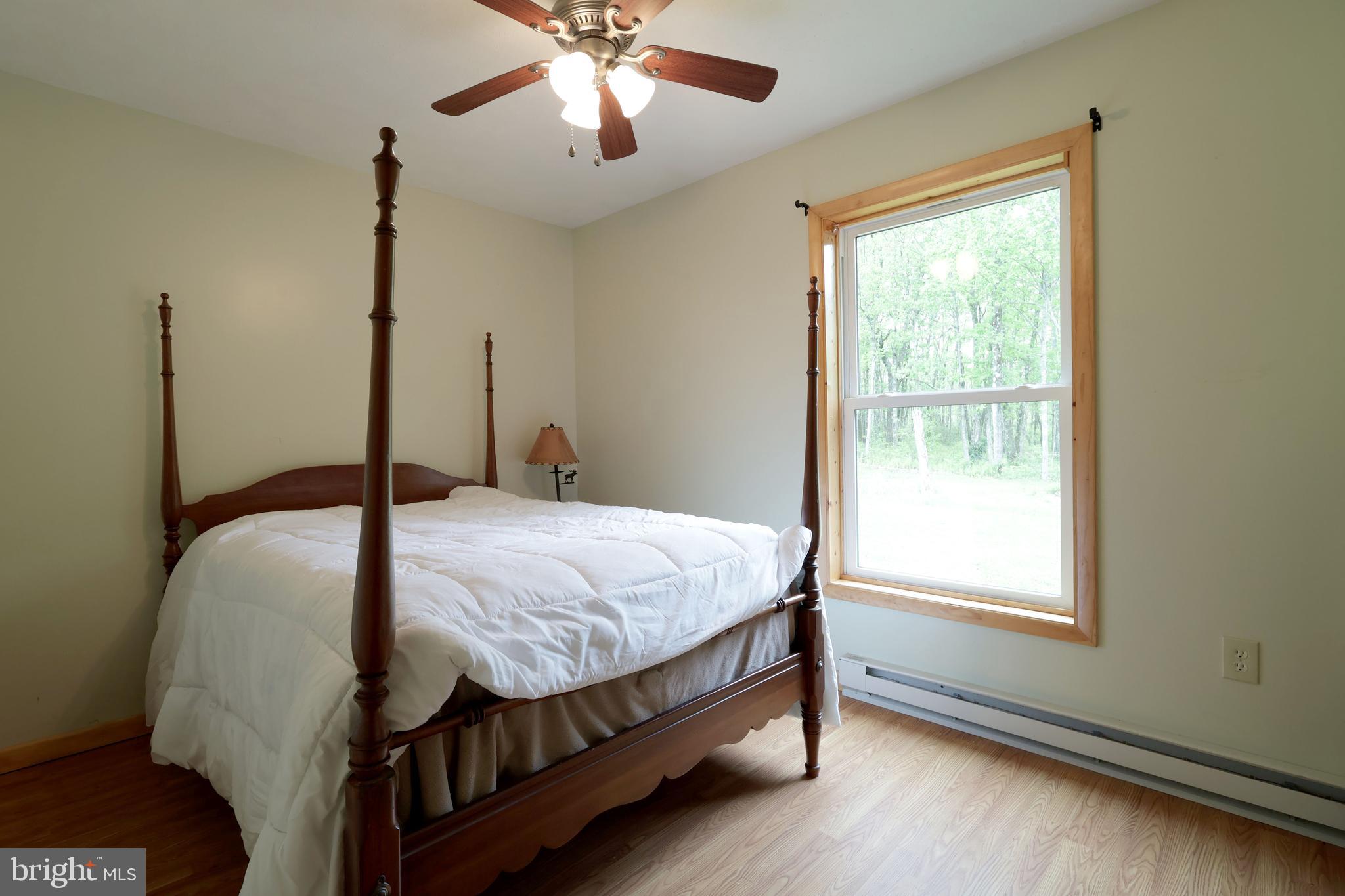 358 Buckridge Road Howard, PA 16841 - Photo 23 of 40 a bedroom with a bed chandelier and a window