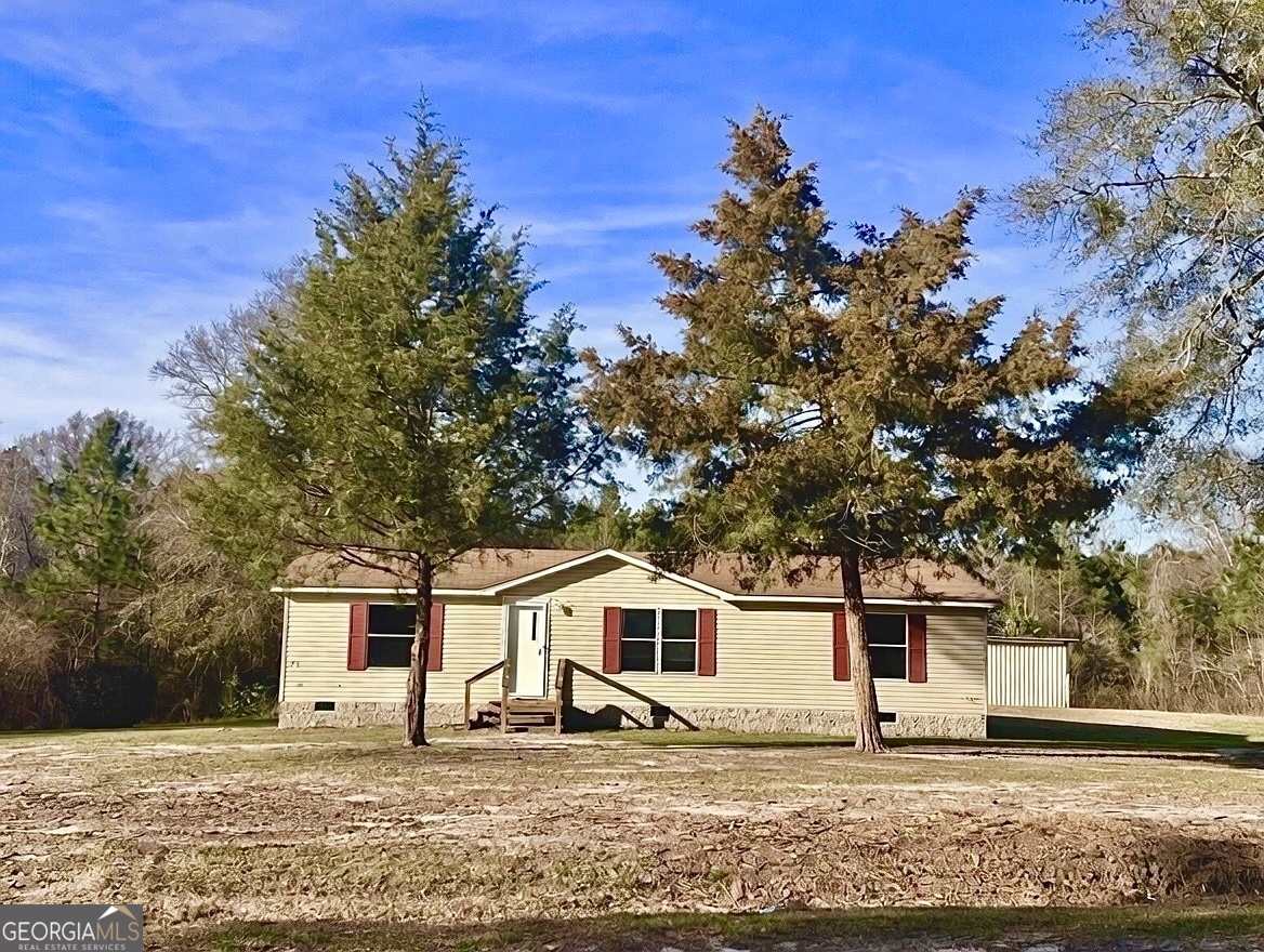 a house that has a tree in front of the house