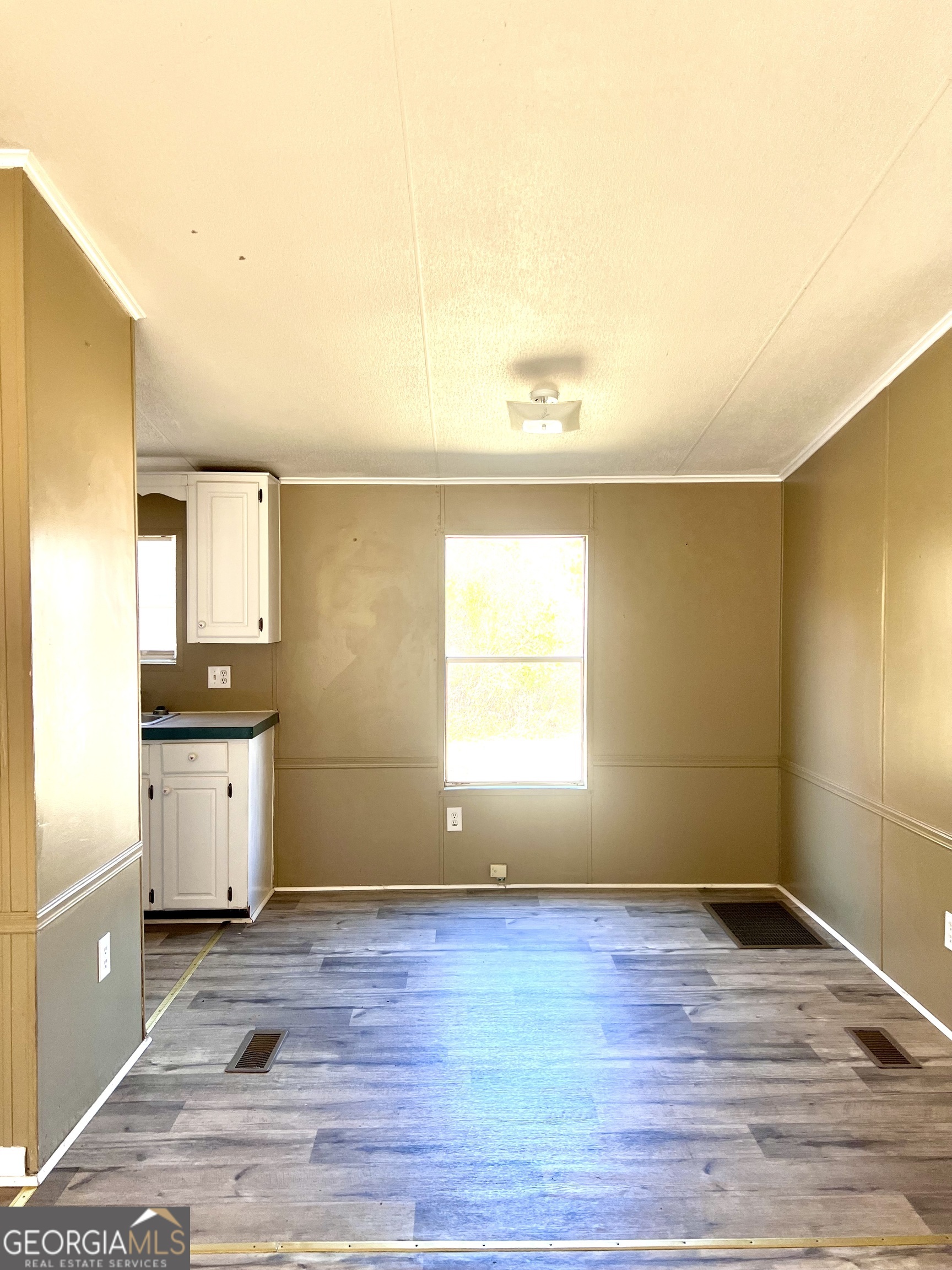 141 Shady Oaks Road Eastman, GA 31023 - Photo 14 of 26 a view of a kitchen with wooden floor and a sink