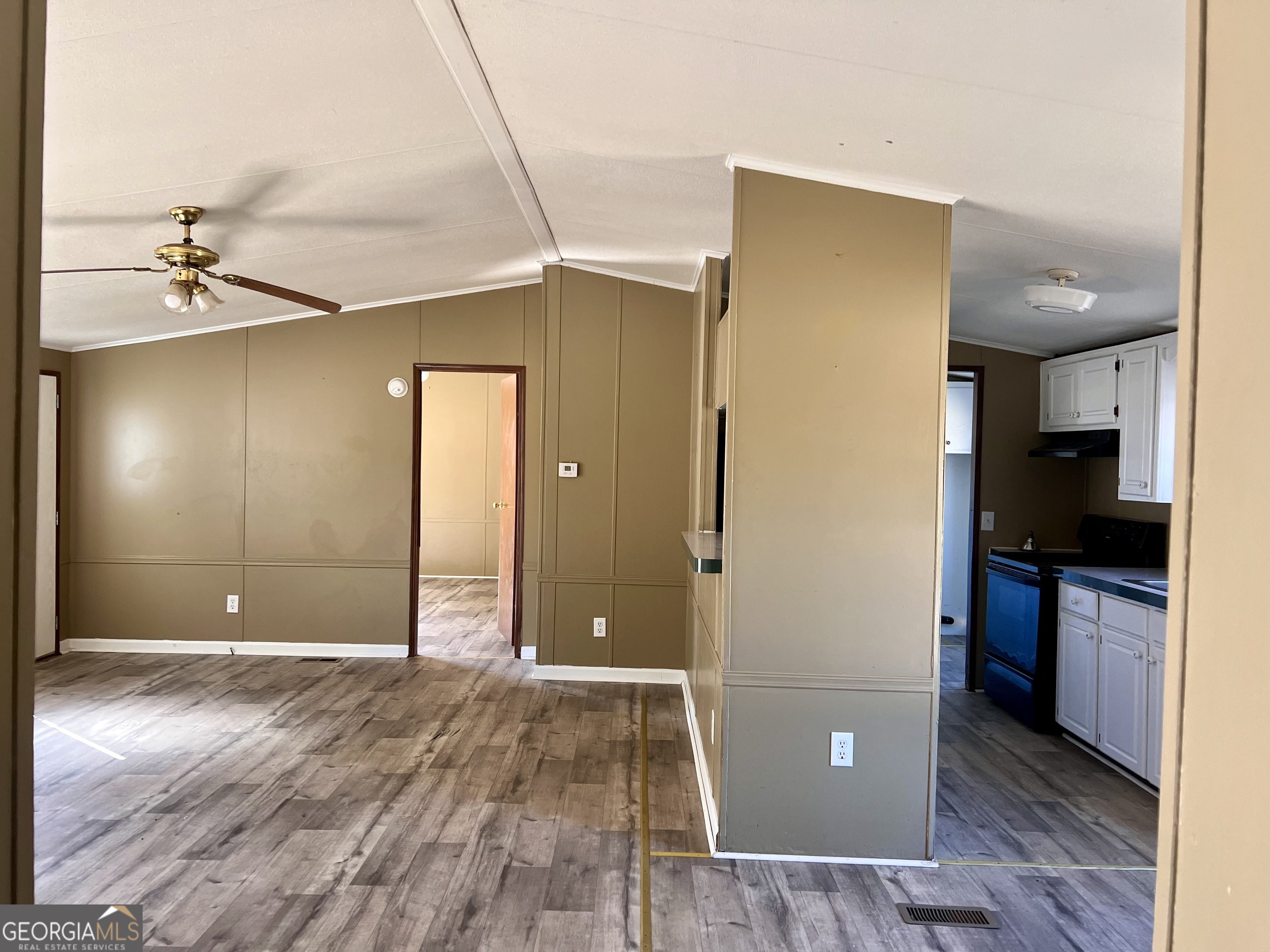 141 Shady Oaks Road Eastman, GA 31023 - Photo 16 of 26 a view of a kitchen with a refrigerator and a stove top oven