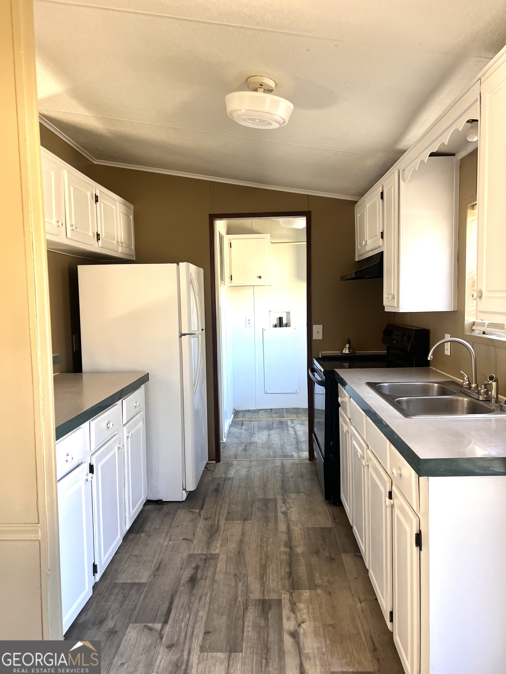 141 Shady Oaks Road Eastman, GA 31023 - Photo 19 of 26 a kitchen with a sink and wooden floor