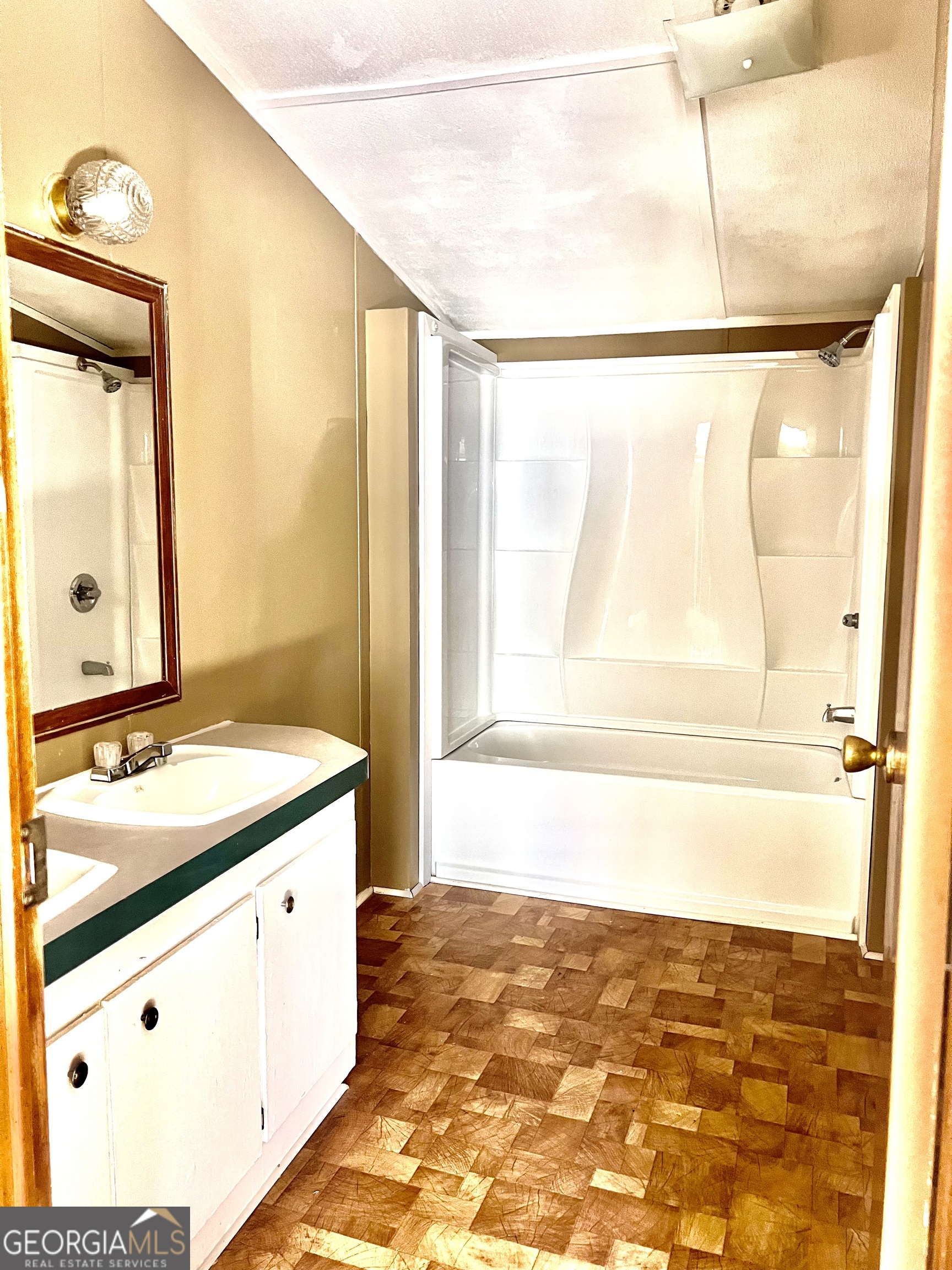 141 Shady Oaks Road Eastman, GA 31023 - Photo 24 of 26 a bathroom with a granite countertop sink mirror and a bathtub