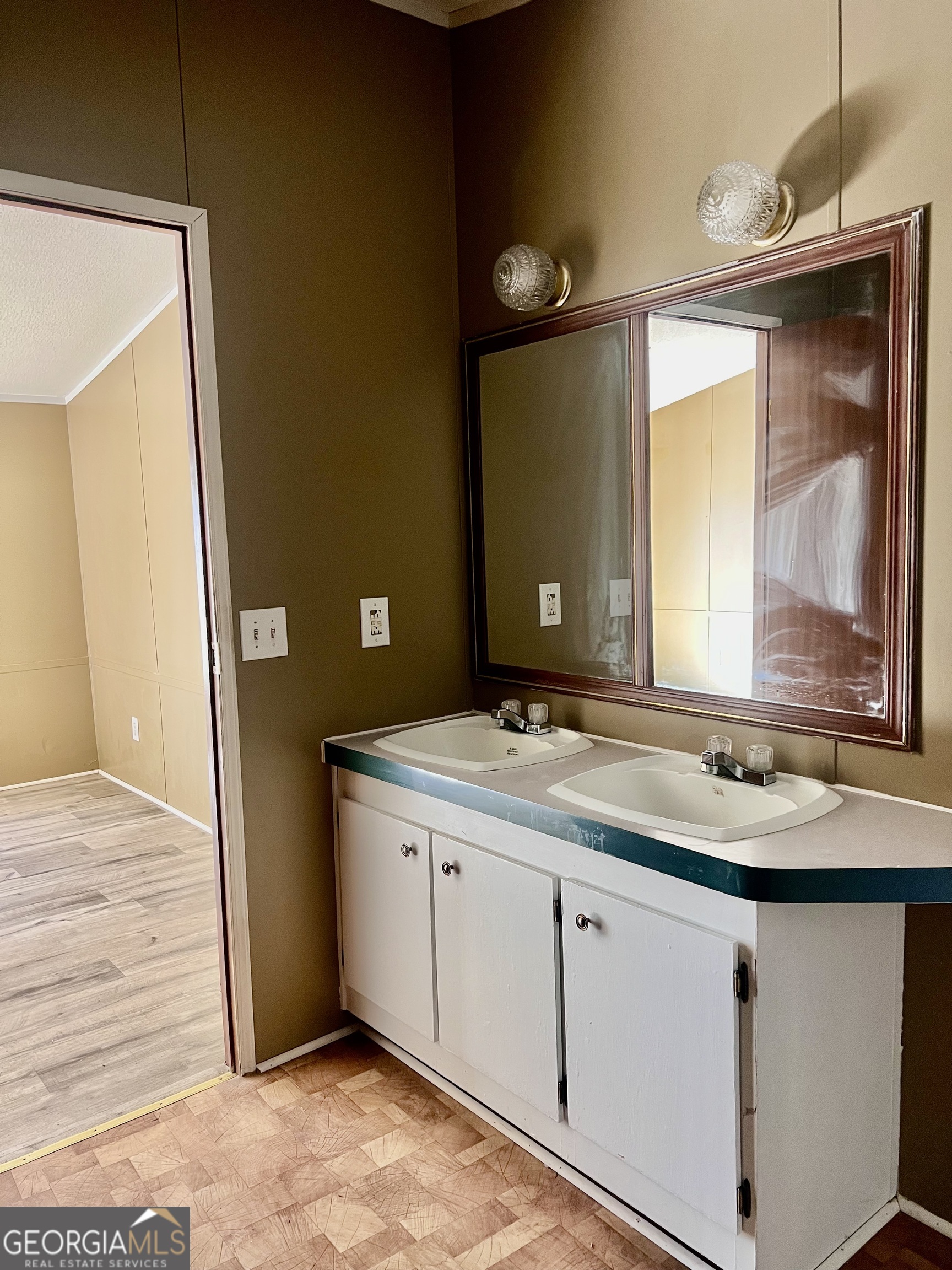 141 Shady Oaks Road Eastman, GA 31023 - Photo 25 of 26 a bathroom with a granite countertop sink and a mirror