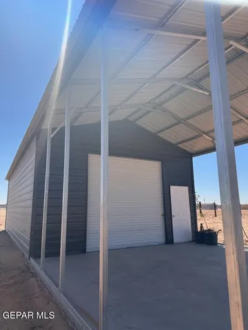 a view of staircase with white walls and door