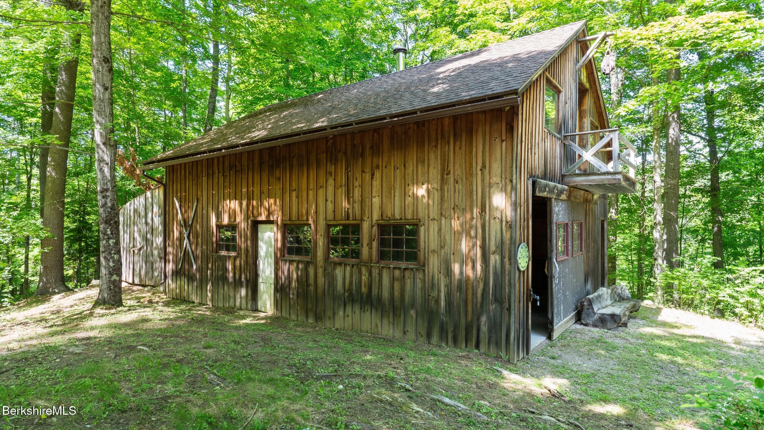 173 Hillsdale Road Egremont, MA 01230 - Photo 78 of 82 a view of backyard with potted plants and a large tree