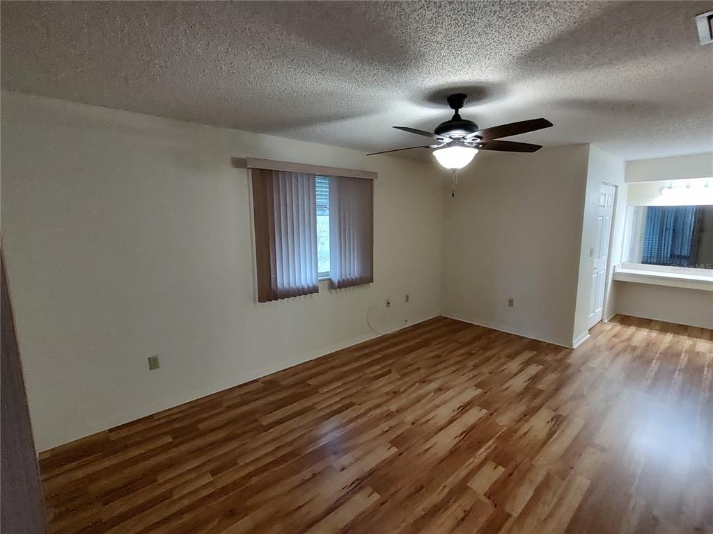 8435 Southwest 109th Lane Ocala, FL 34481 - Photo 13 of 28 a view of empty room with wooden floor