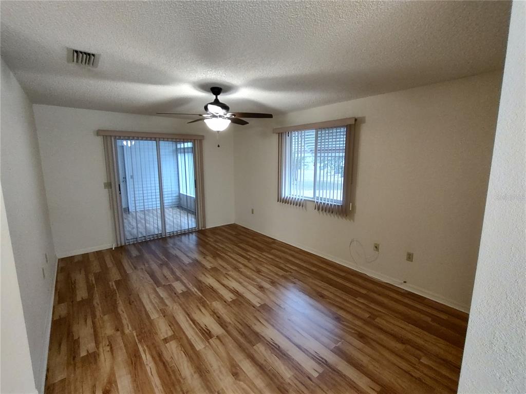 8435 Southwest 109th Lane Ocala, FL 34481 - Photo 15 of 28 a view of empty room with wooden floor and fan