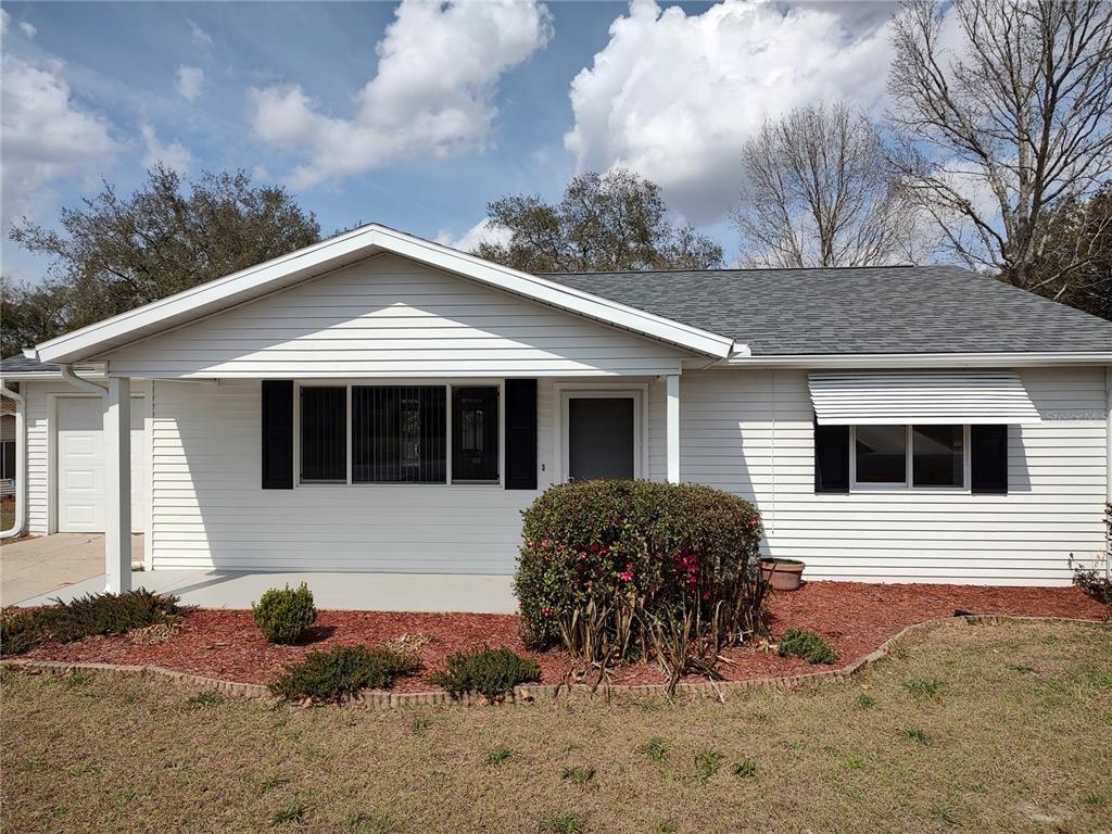 8435 Southwest 109th Lane Ocala, FL 34481 - Photo 2 of 28 a front view of a house with a yard