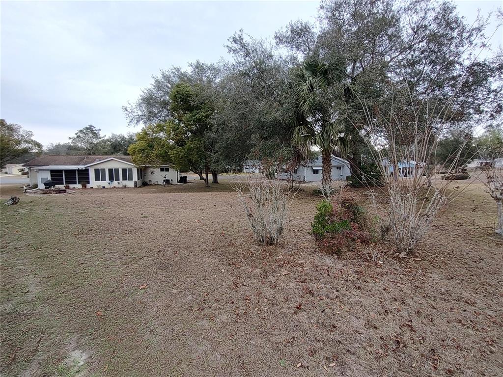 8435 Southwest 109th Lane Ocala, FL 34481 - Photo 27 of 28 a view of a town with large trees