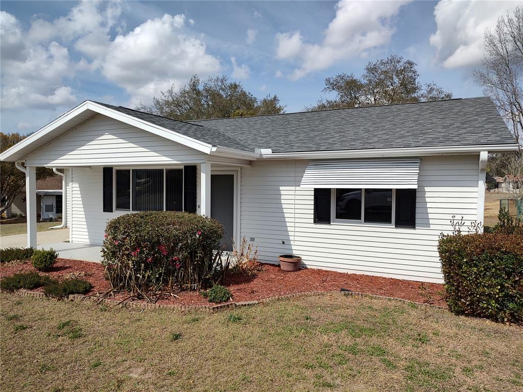 8435 Southwest 109th Lane Ocala, FL 34481 - Photo 3 of 28 a front view of a house with a yard