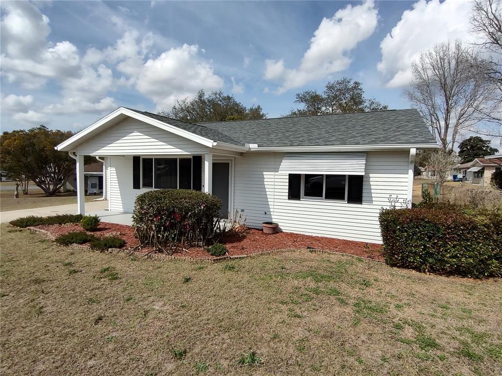 8435 Southwest 109th Lane Ocala, FL 34481 - Photo 4 of 28 a front view of a house with garden