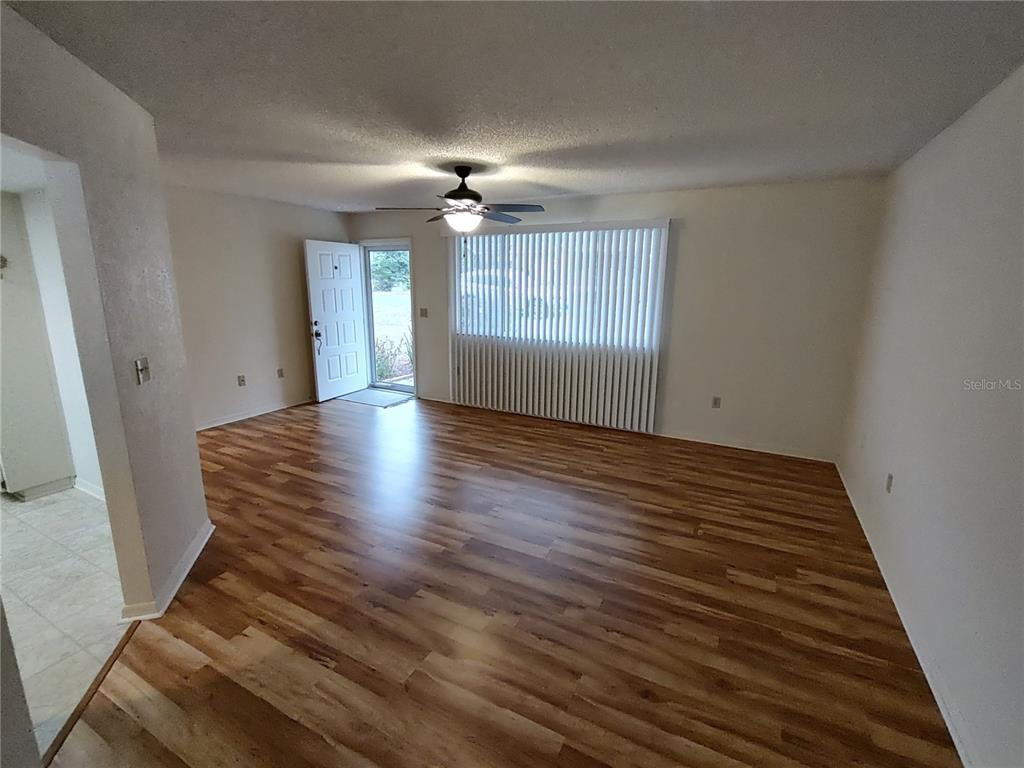 8435 Southwest 109th Lane Ocala, FL 34481 - Photo 7 of 28 wooden floor in an empty room with a window