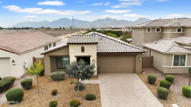 a front view of a house with a garden
