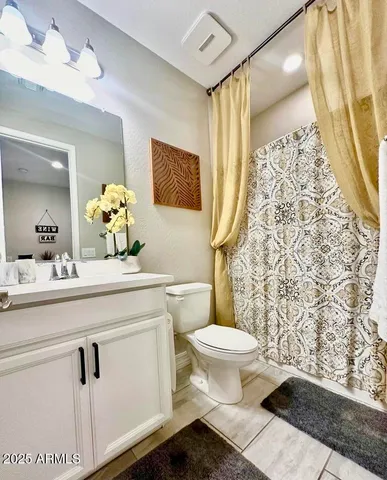 a bedroom with a large bed and a rug