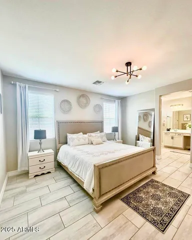 a large white kitchen with kitchen island a sink a counter top space and stainless steel appliances