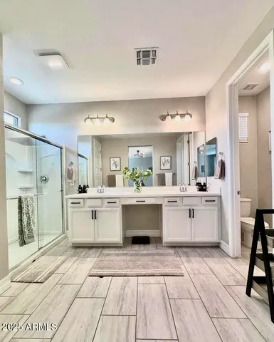 a view of an empty room with cabinet and a window