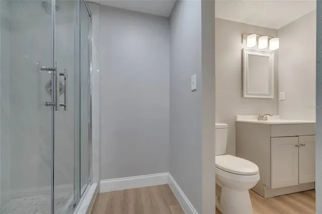 a view of empty room with wooden floor