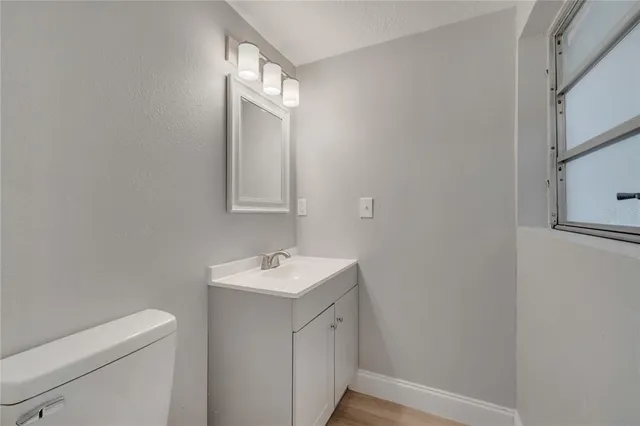 a view of hallway with a large window and wooden floor