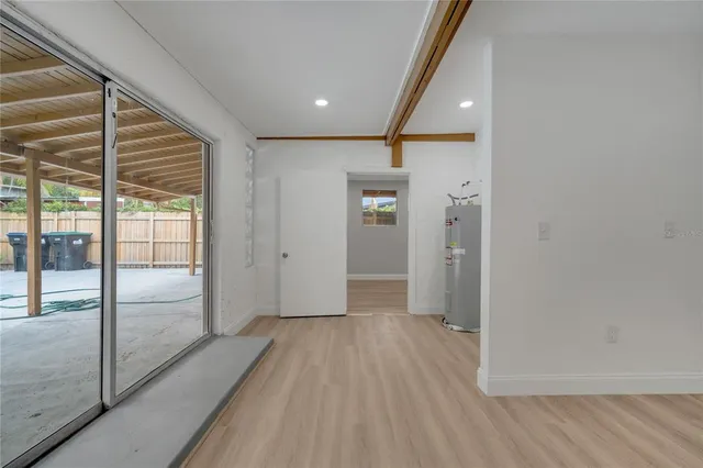a kitchen with a refrigerator sink and cabinets