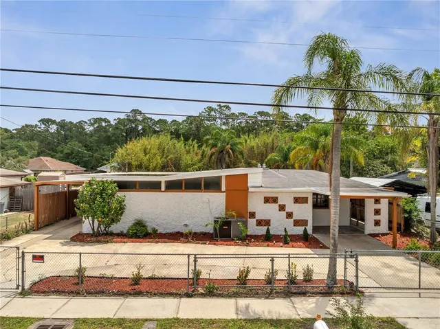 a view of a brick house with a floor to ceiling windows and outdoor space