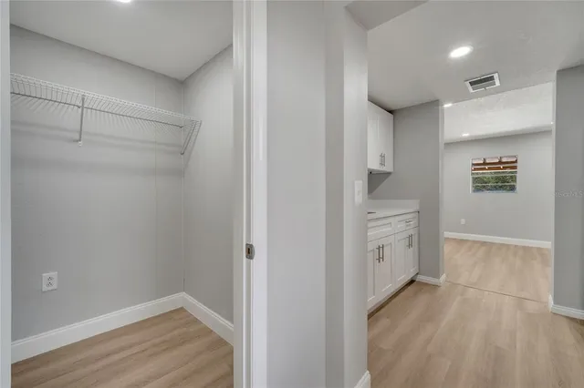 a kitchen with stainless steel appliances granite countertop a sink stove and wooden floor
