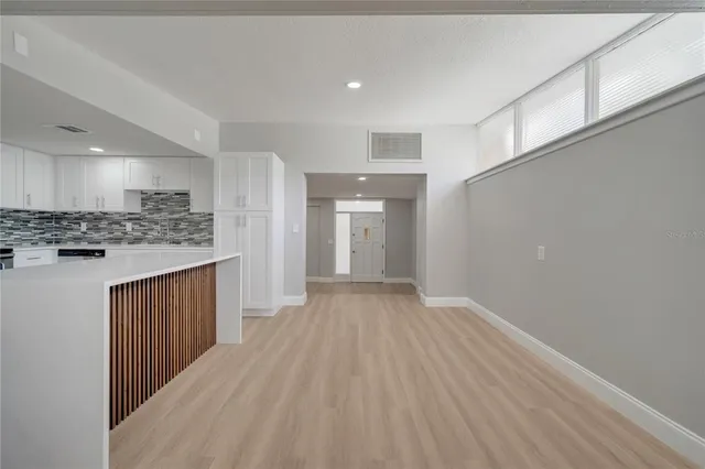 a view of a kitchen with a sink and a refrigerator