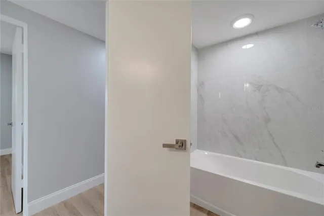 a bathroom with a toilet sink vanity and mirror