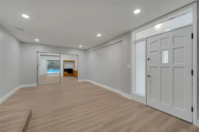a view of an empty room with wooden floor