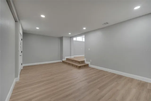 a spacious bathroom with a double vanity sink and mirror