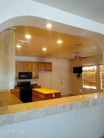 a kitchen with stainless steel appliances granite countertop a sink and a stove top oven