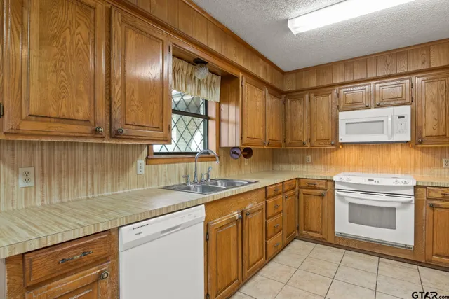 a kitchen with a sink stove and refrigerator