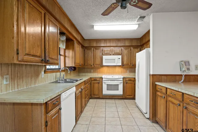 a view of a dining room with furniture a chandelier and wooden floor