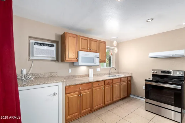 a kitchen with a sink stove and cabinets