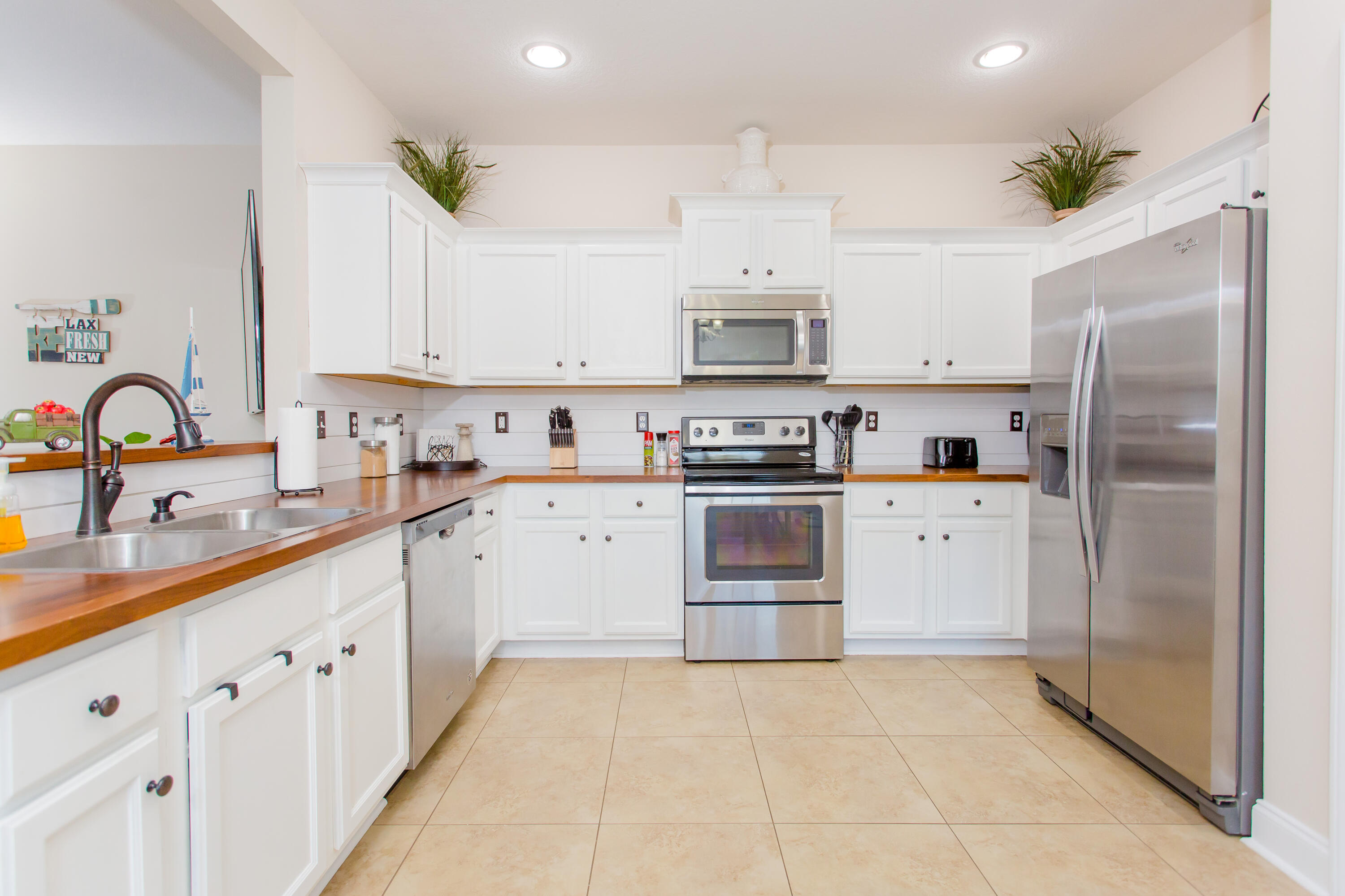 4544 Live Oak Church Road Crestview, FL 32539 - Photo 11 of 31 a kitchen with kitchen island white cabinets and refrigerator
