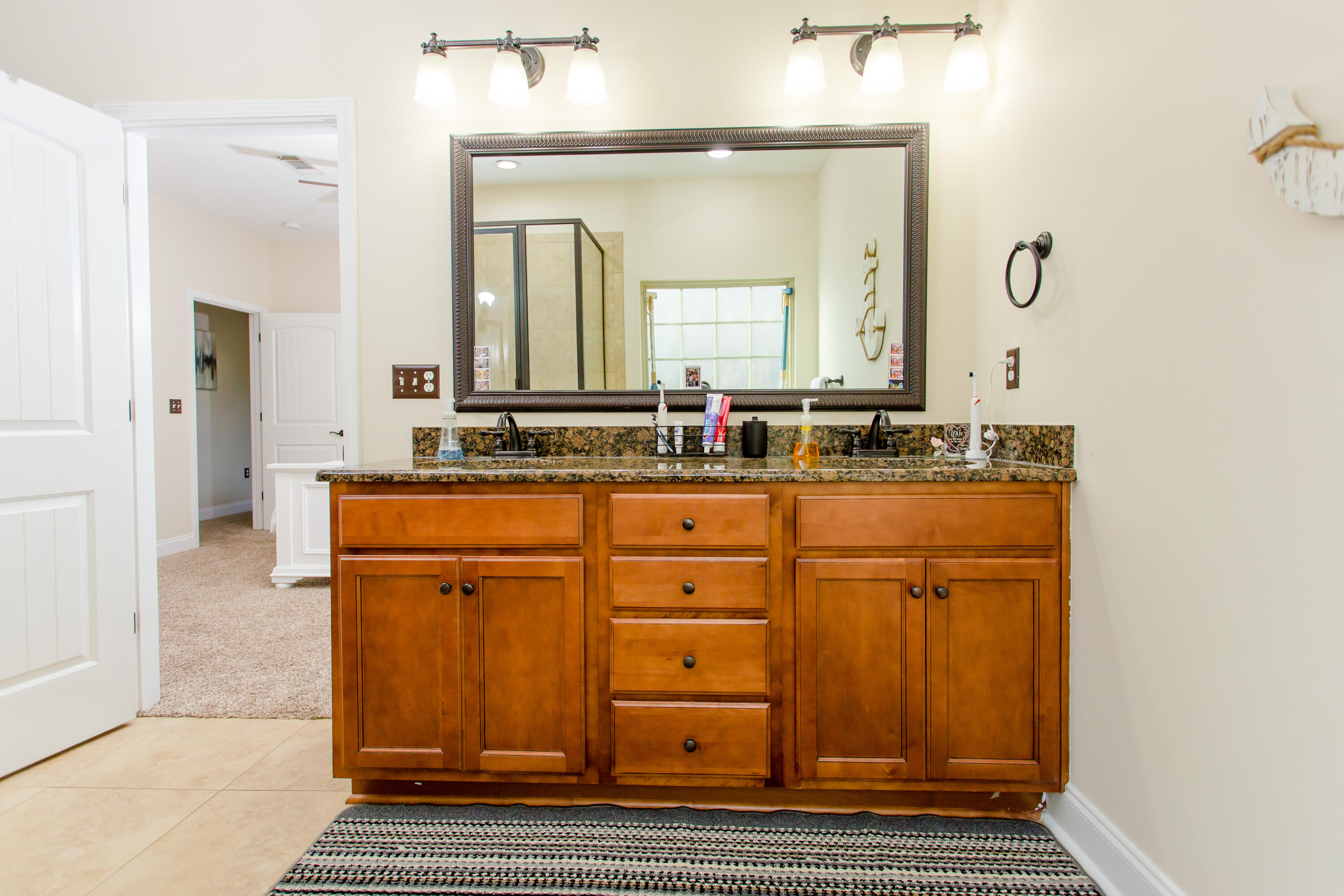 4544 Live Oak Church Road Crestview, FL 32539 - Photo 18 of 31 a bathroom with a granite countertop sink and a mirror